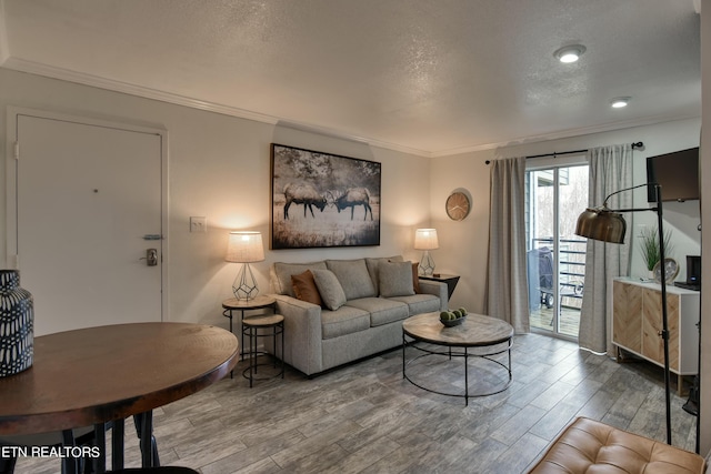 living room with wood-type flooring and crown molding