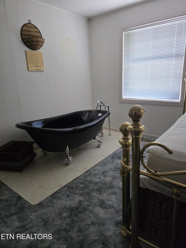 bedroom featuring wooden walls