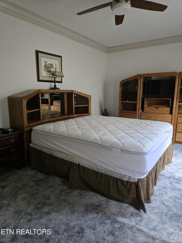 bedroom with a textured ceiling, carpet floors, ceiling fan, and ornamental molding