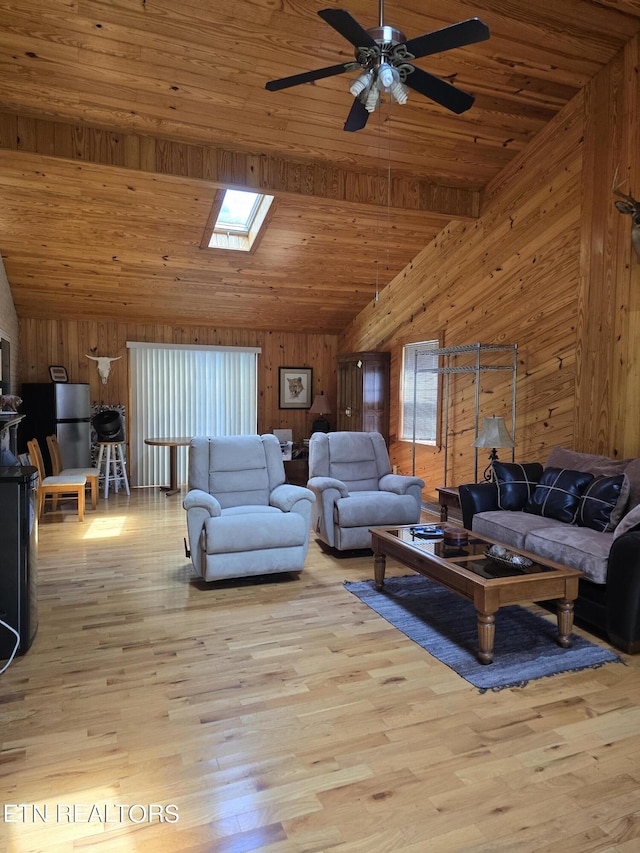 living room with wooden walls, ceiling fan, wooden ceiling, and light hardwood / wood-style floors