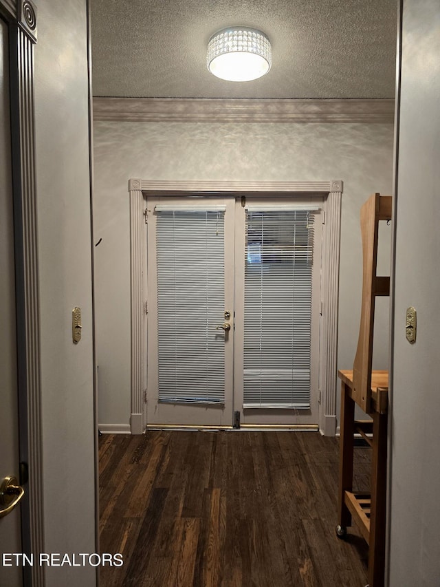 entryway with a textured ceiling and dark wood-type flooring