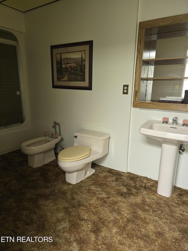 bathroom with toilet, sink, and a bidet