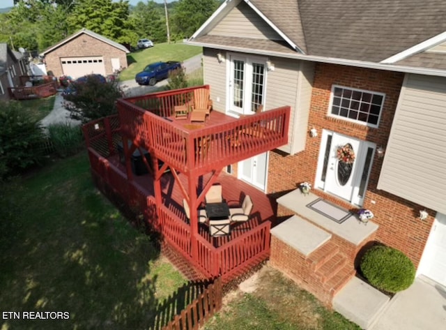 deck featuring an outdoor structure and a garage