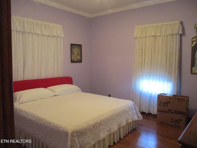 bedroom featuring dark wood-type flooring and crown molding