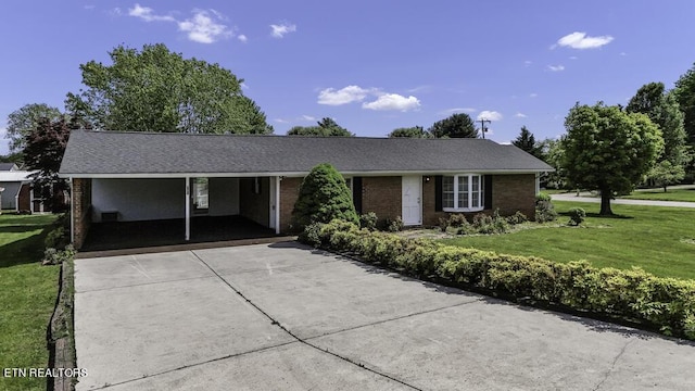 ranch-style house featuring a front lawn and a carport