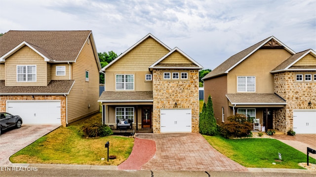 view of front of property with a garage and a front lawn