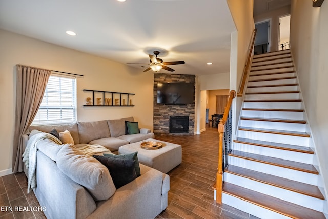 living room with a fireplace, ceiling fan, and dark hardwood / wood-style floors