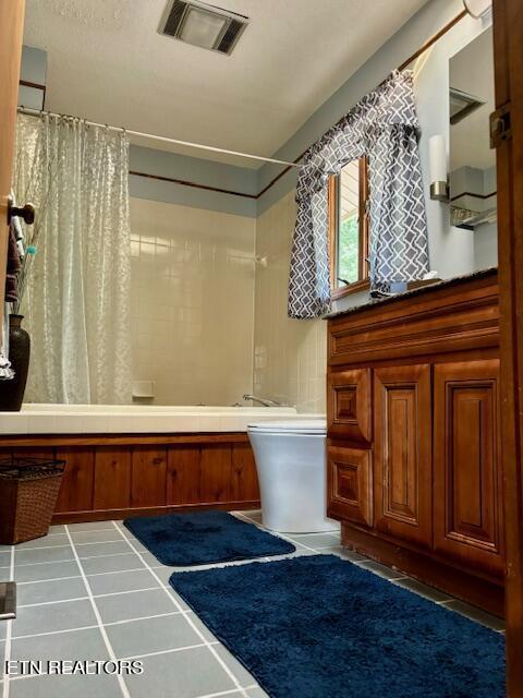 bathroom with shower / tub combo, visible vents, toilet, and tile patterned floors