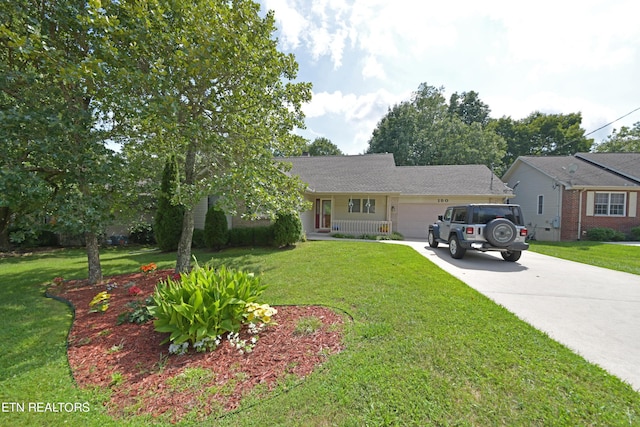 ranch-style home featuring a garage and a front lawn