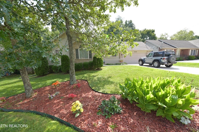 view of front of home featuring a garage and a front lawn