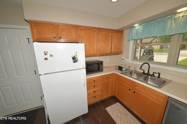 kitchen with white refrigerator, stainless steel dishwasher, dark hardwood / wood-style floors, and sink