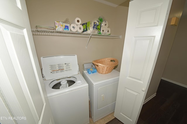 clothes washing area featuring separate washer and dryer