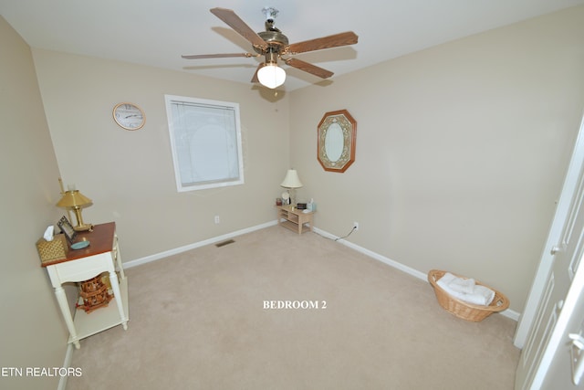 unfurnished room with light colored carpet and ceiling fan