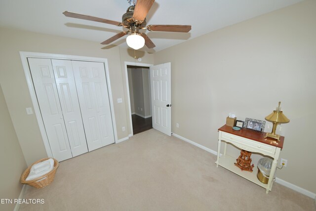 carpeted bedroom featuring ceiling fan and a closet