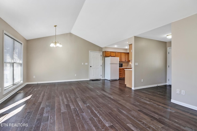 unfurnished living room with lofted ceiling, dark wood-type flooring, and a chandelier