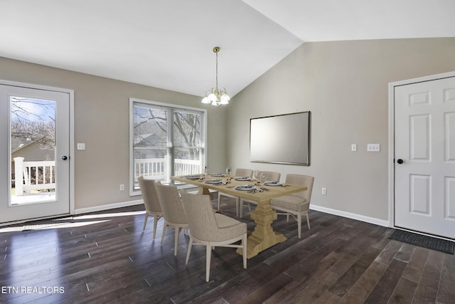 dining room with lofted ceiling, dark hardwood / wood-style floors, and a notable chandelier