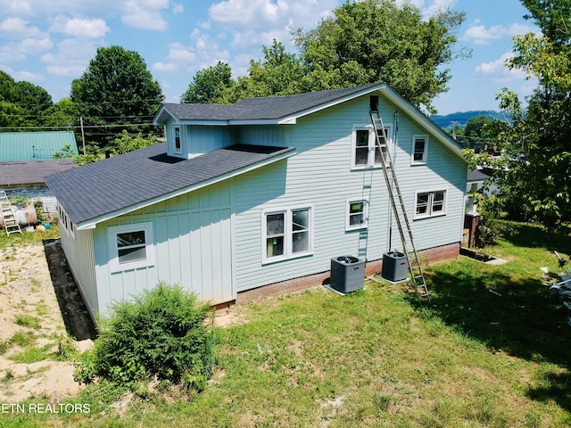 back of house with a yard and cooling unit