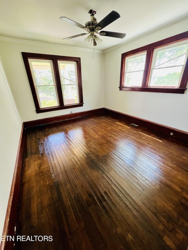 spare room with crown molding, ceiling fan, and dark wood-type flooring