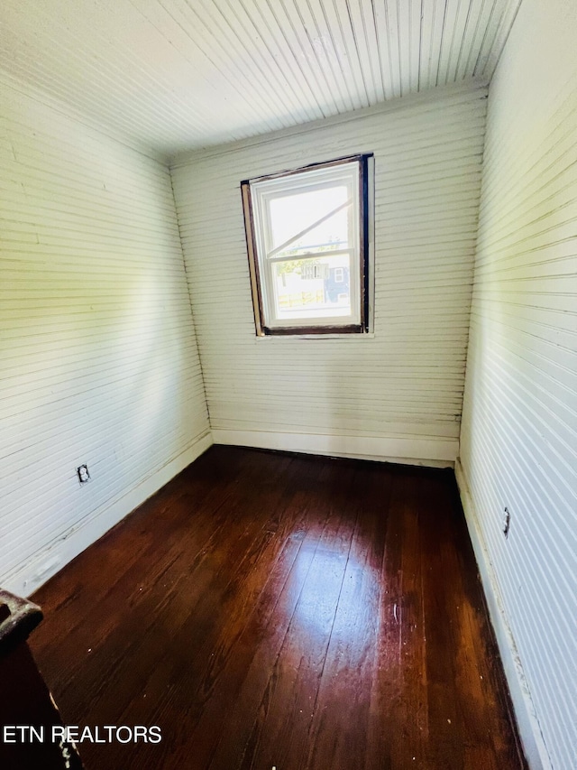 unfurnished room with dark hardwood / wood-style flooring