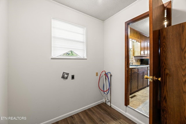 laundry area featuring crown molding, dark hardwood / wood-style floors, washer hookup, a textured ceiling, and hookup for an electric dryer