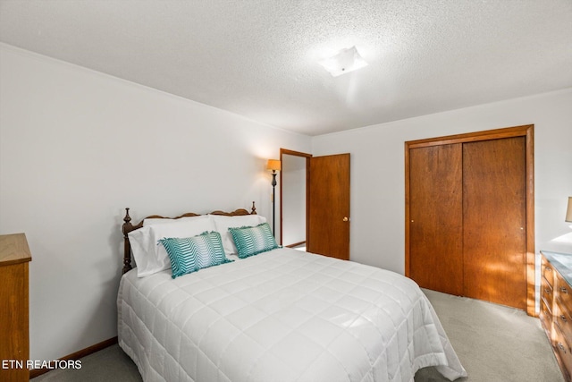 bedroom featuring a closet, a textured ceiling, and carpet flooring