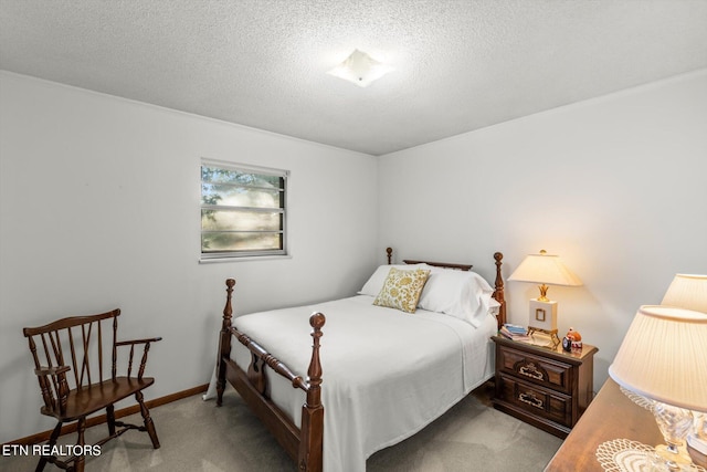 bedroom featuring light carpet and a textured ceiling