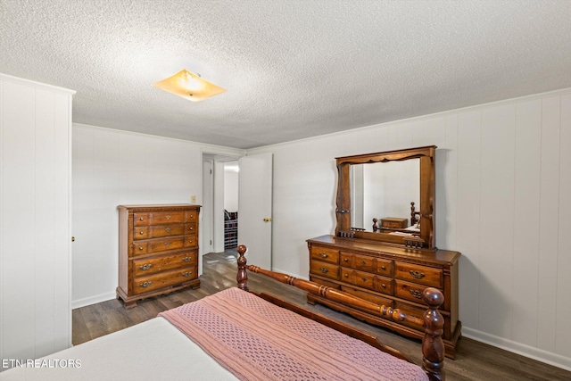 bedroom with dark wood-type flooring and a textured ceiling