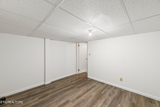 basement featuring hardwood / wood-style flooring and a paneled ceiling