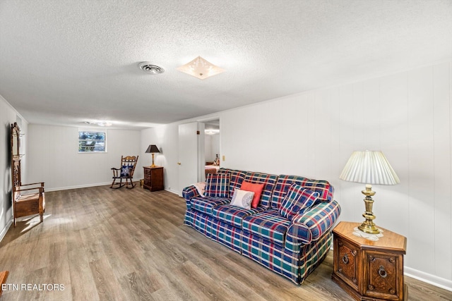 sitting room featuring hardwood / wood-style flooring and a textured ceiling