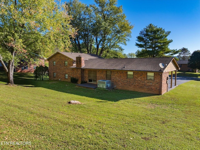 view of property exterior with central AC and a yard