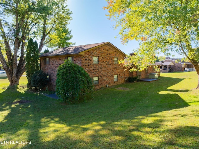 view of side of property with a yard