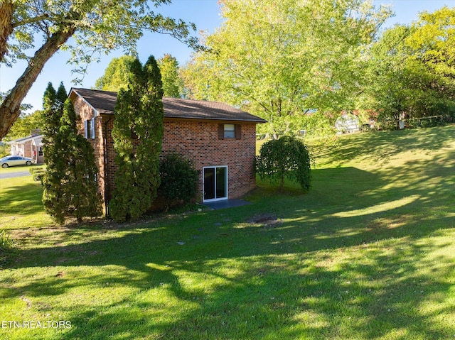 view of side of home featuring a lawn