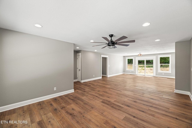 unfurnished living room featuring ceiling fan and hardwood / wood-style flooring