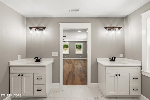 bathroom with ceiling fan and vanity