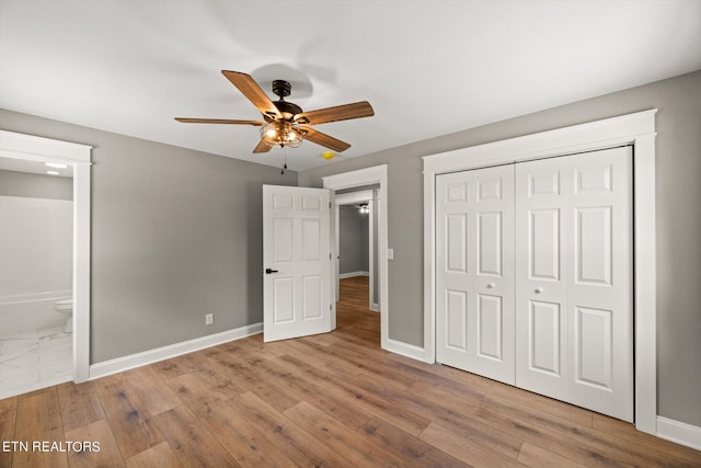 unfurnished bedroom with ceiling fan, a closet, connected bathroom, and light hardwood / wood-style flooring