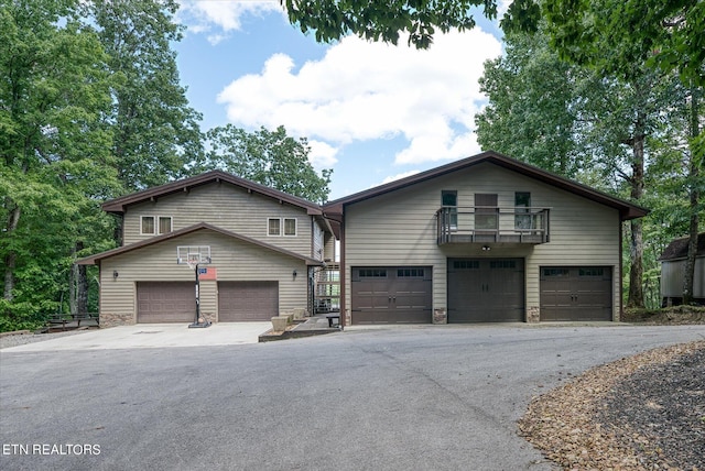 view of front of house featuring a balcony and a garage