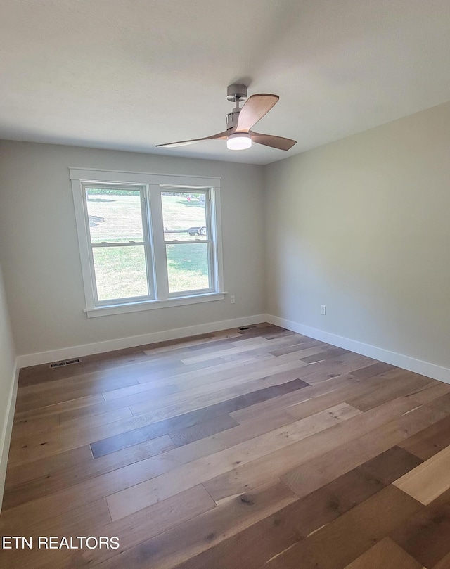 empty room with ceiling fan and light wood-type flooring