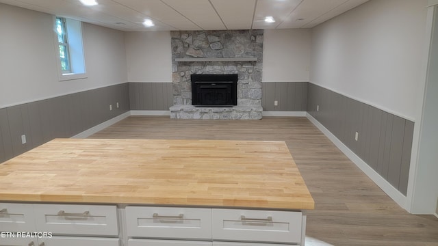 unfurnished living room featuring light wood-type flooring and a fireplace