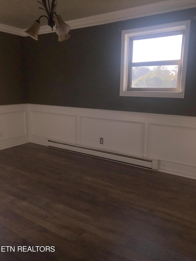 unfurnished room with dark hardwood / wood-style flooring, ornamental molding, and a baseboard heating unit