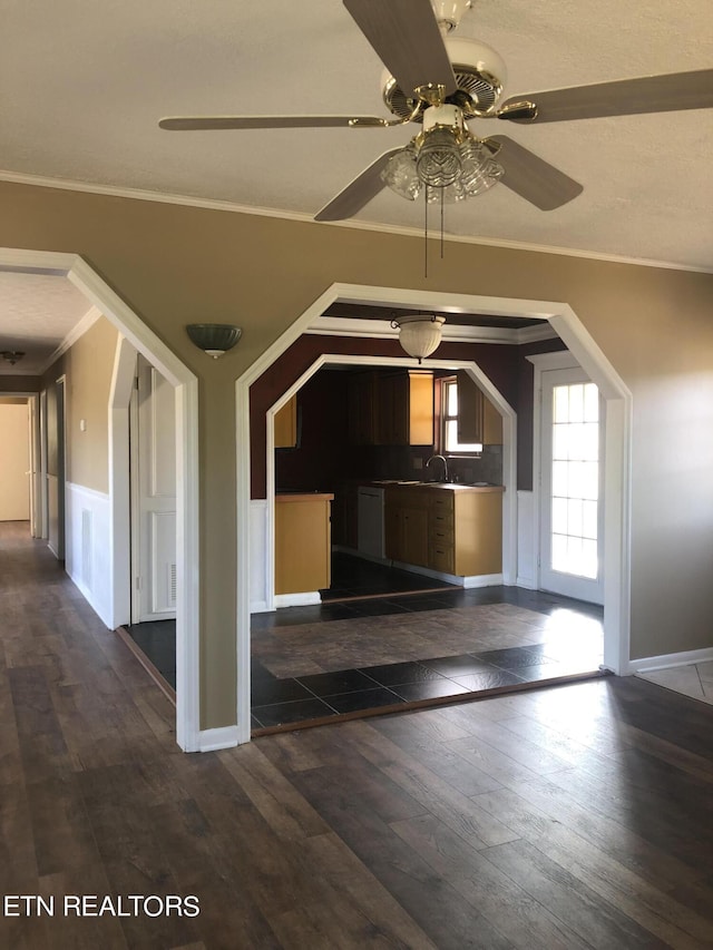 foyer featuring dark hardwood / wood-style flooring, ceiling fan, ornamental molding, and sink