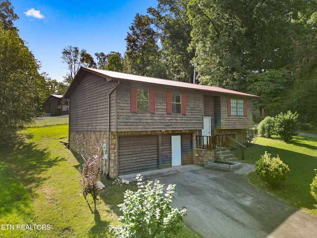 raised ranch featuring a front lawn