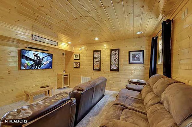 carpeted home theater room with wooden ceiling and wooden walls