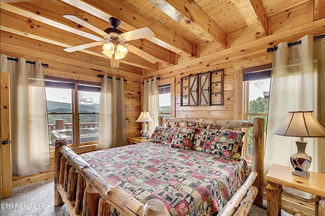 bedroom featuring ceiling fan, wooden ceiling, carpet floors, wooden walls, and beamed ceiling