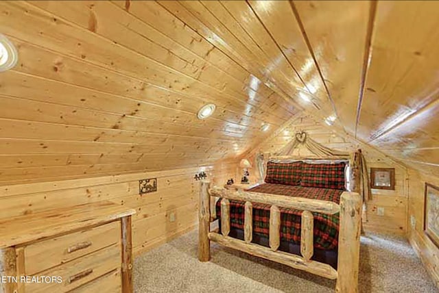 carpeted bedroom featuring lofted ceiling, wood walls, and wooden ceiling