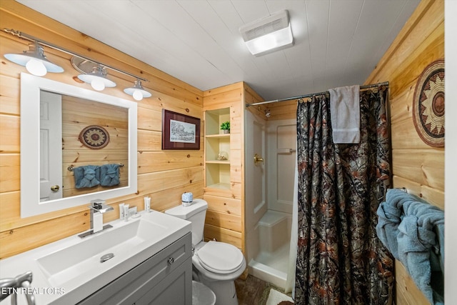 bathroom with vanity, a shower with shower curtain, toilet, and wooden walls