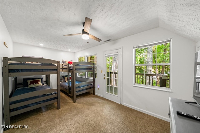 bedroom featuring vaulted ceiling, ceiling fan, and a textured ceiling