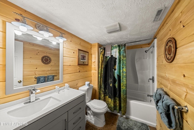 full bathroom with toilet, vanity, wood walls, a textured ceiling, and shower / bath combo with shower curtain