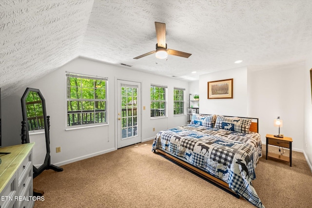 bedroom featuring a textured ceiling, lofted ceiling, access to outside, ceiling fan, and light colored carpet