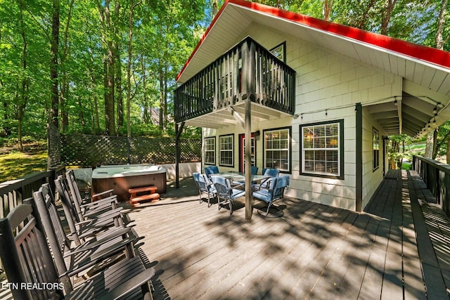 wooden terrace featuring a hot tub