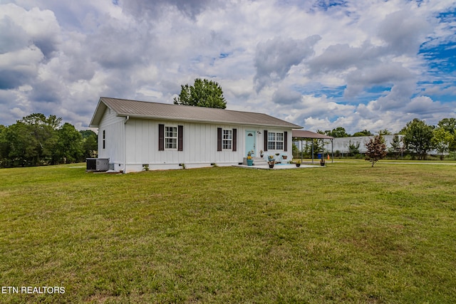 view of front of home featuring central AC unit and a front lawn